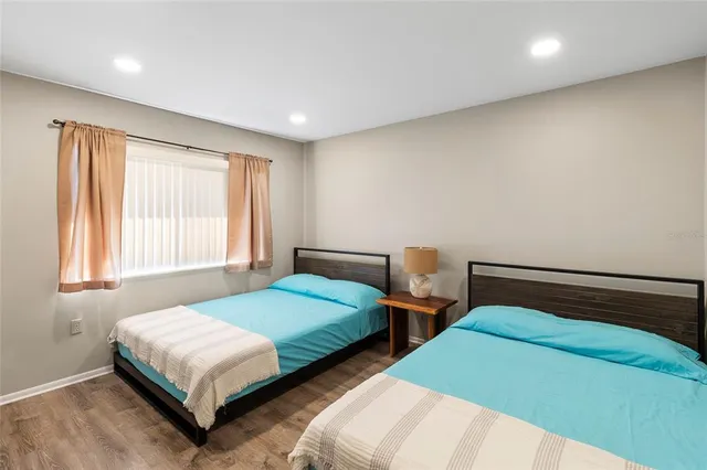 a bedroom with two beds and window