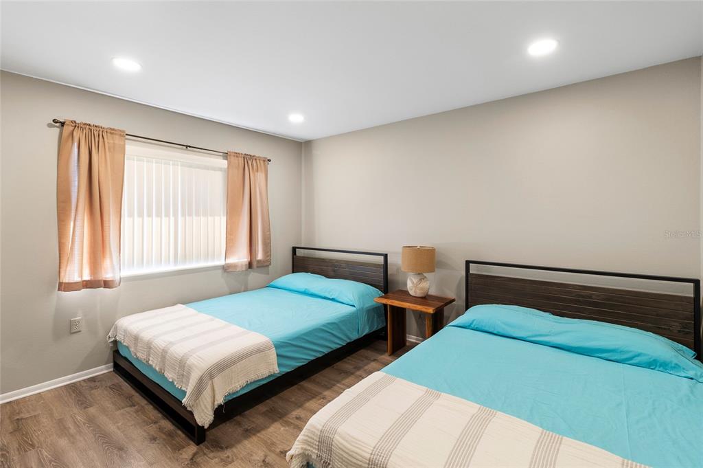 1579 Greenlea Drive, Unit 12 Clearwater, FL 33755 - Photo 29 of 42 a bedroom with two beds and window