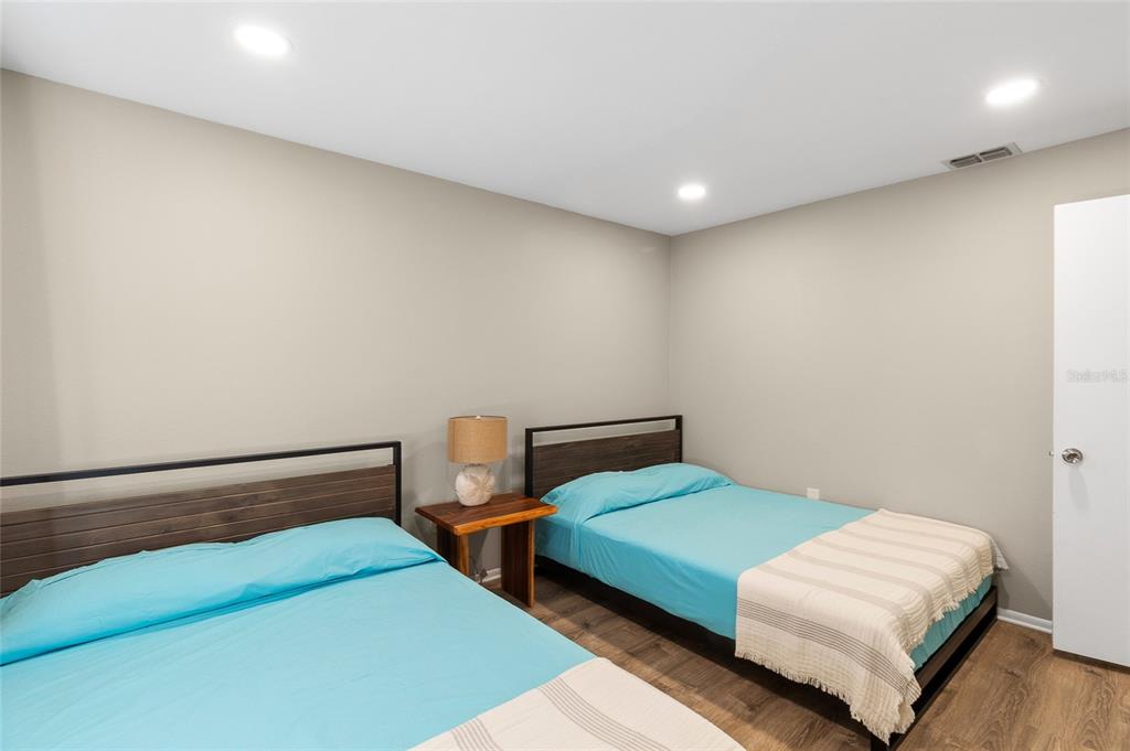 1579 Greenlea Drive, Unit 12 Clearwater, FL 33755 - Photo 30 of 42 a bedroom with a bed and painted walls