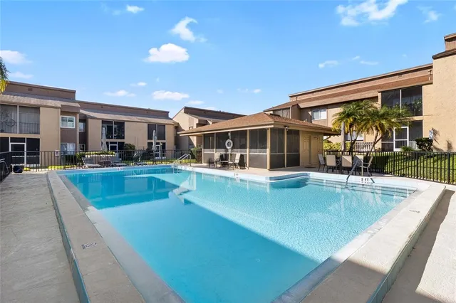 a view of a house with swimming pool and sitting area