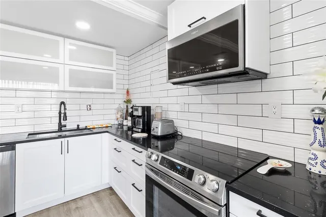 a kitchen with stainless steel appliances a stove and a microwave
