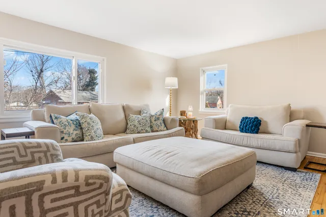 a large bed sitting in a bedroom next to a window