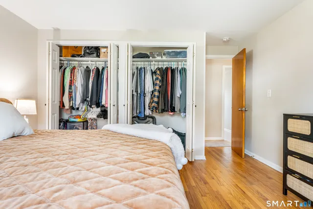 a bedroom with a bed and a wall painting