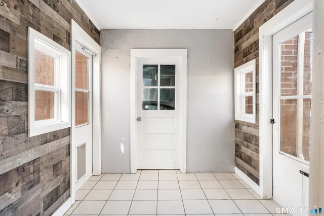 a view of a house with a yard and a tree