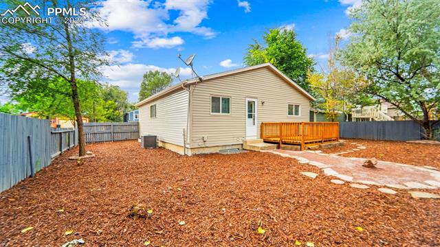 562 Blossom Field Road Fountain, CO 80817 - Photo 36 of 41 Back of house with a fenced backyard and a deck
