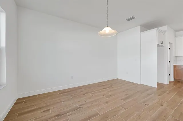 a view of a room with wooden floor