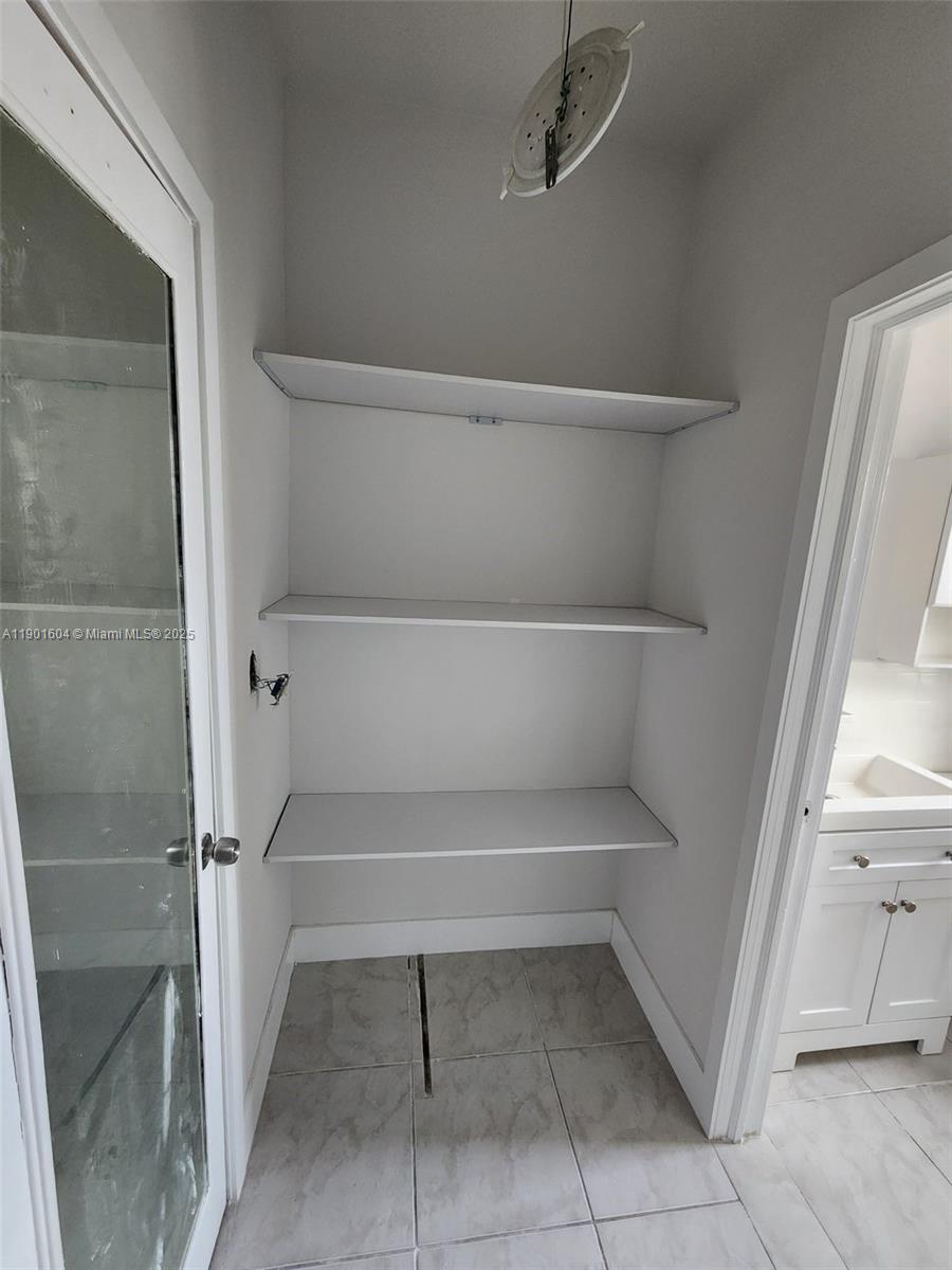 7611 Harding Avenue, Unit 9 Miami Beach, FL 33141 - Photo 12 of 15 a view of store room with racks