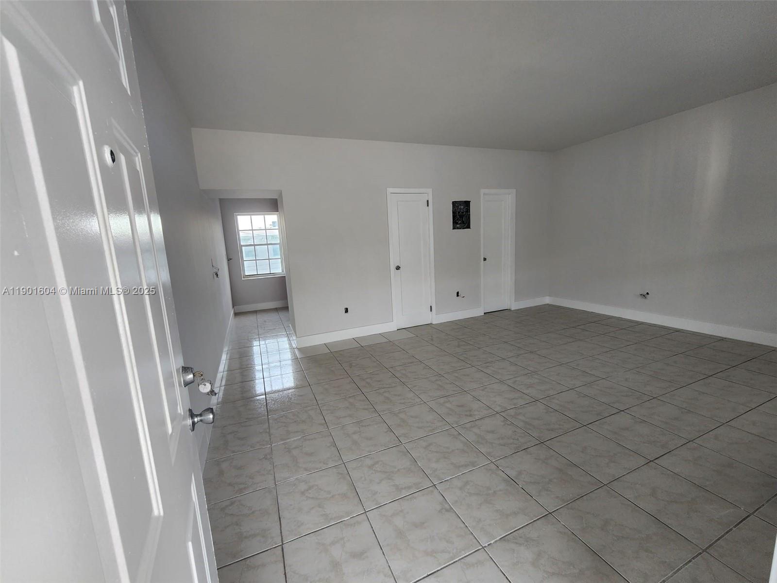 7611 Harding Avenue, Unit 9 Miami Beach, FL 33141 - Photo 4 of 15 an empty room with a fireplace