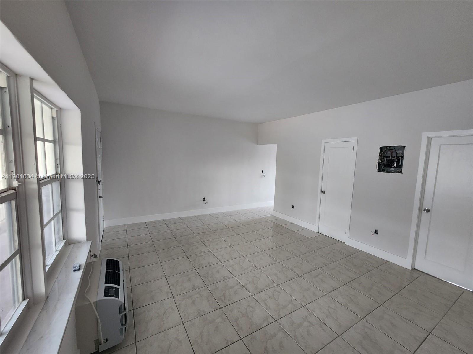 7611 Harding Avenue, Unit 9 Miami Beach, FL 33141 - Photo 6 of 15 a view of an empty room with a window