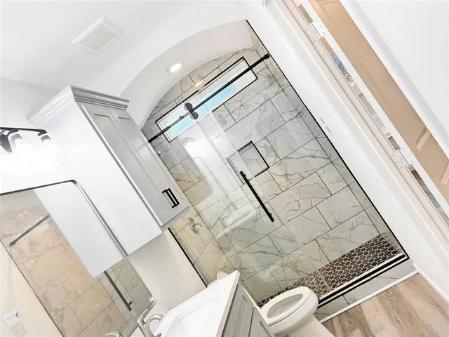 a bathroom with a toilet and a shower