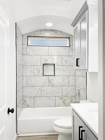 a bathroom with a toilet and a shower