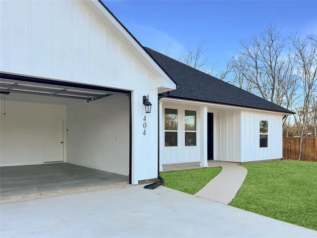 a view of a house with a yard and garage
