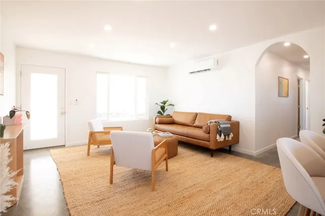 a bedroom with furniture and a potted plant