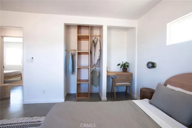 a bedroom with a large bed and a window