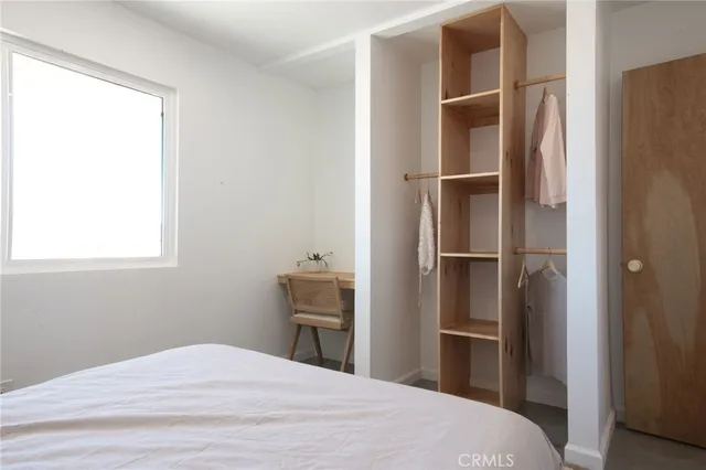 a bedroom with a bed and a window