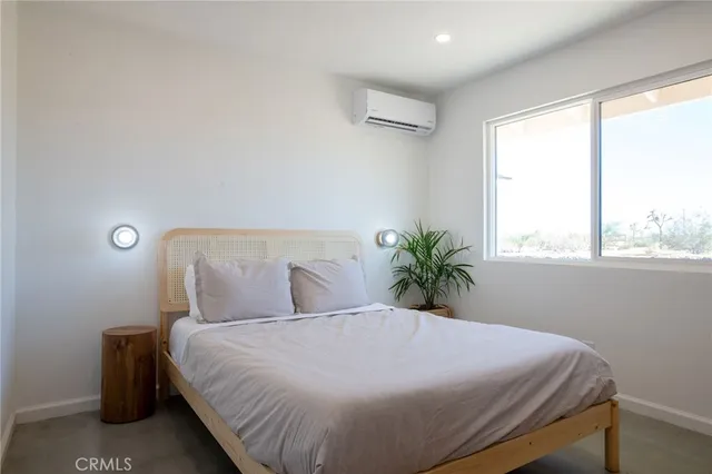 a bedroom with a bed and table