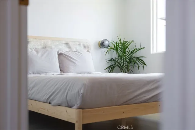 a bedroom with a bed and window