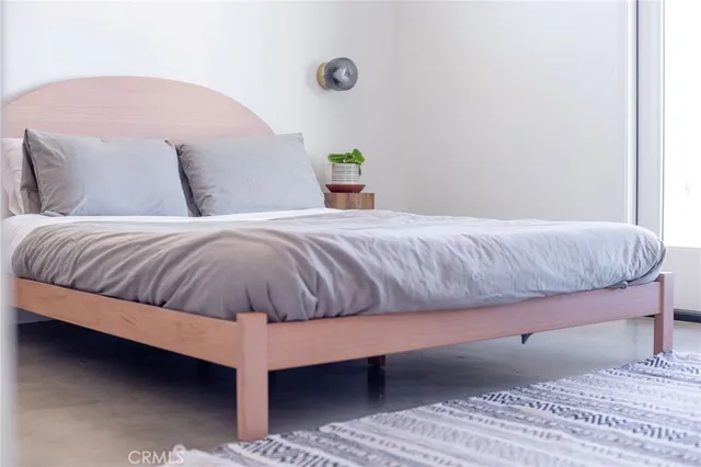 a view of living room and bedroom with furniture