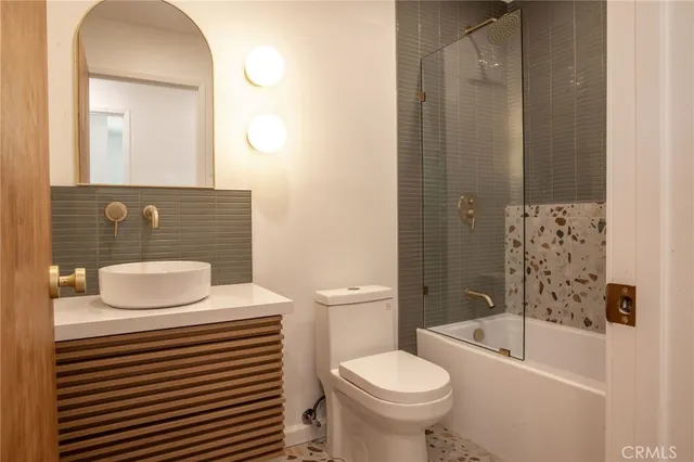 a bathroom with a sink mirror and vanity