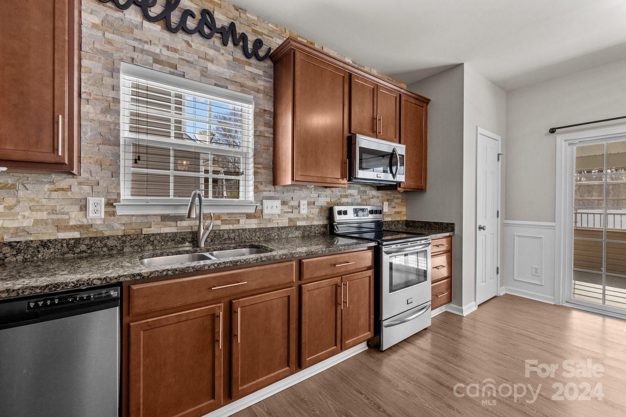 1653 Beleek Ridge Lane Clover, SC 29710 - Photo 13 of 46 a kitchen with stainless steel appliances granite countertop a sink stove and cabinets