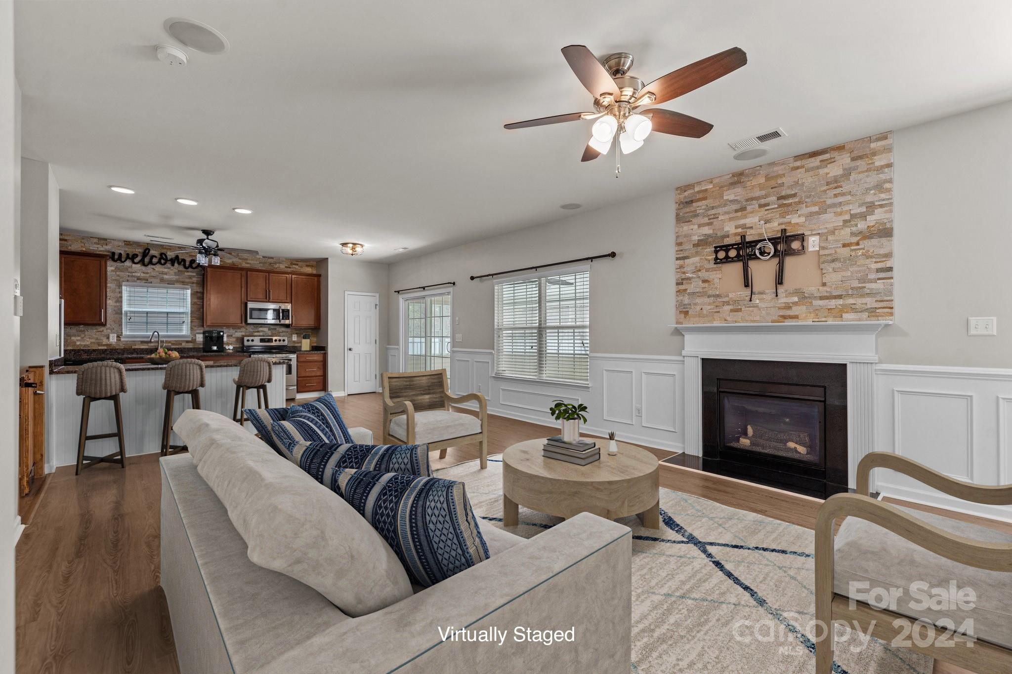 1653 Beleek Ridge Lane Clover, SC 29710 - Photo 16 of 46 a living room with furniture kitchen view and a fireplace