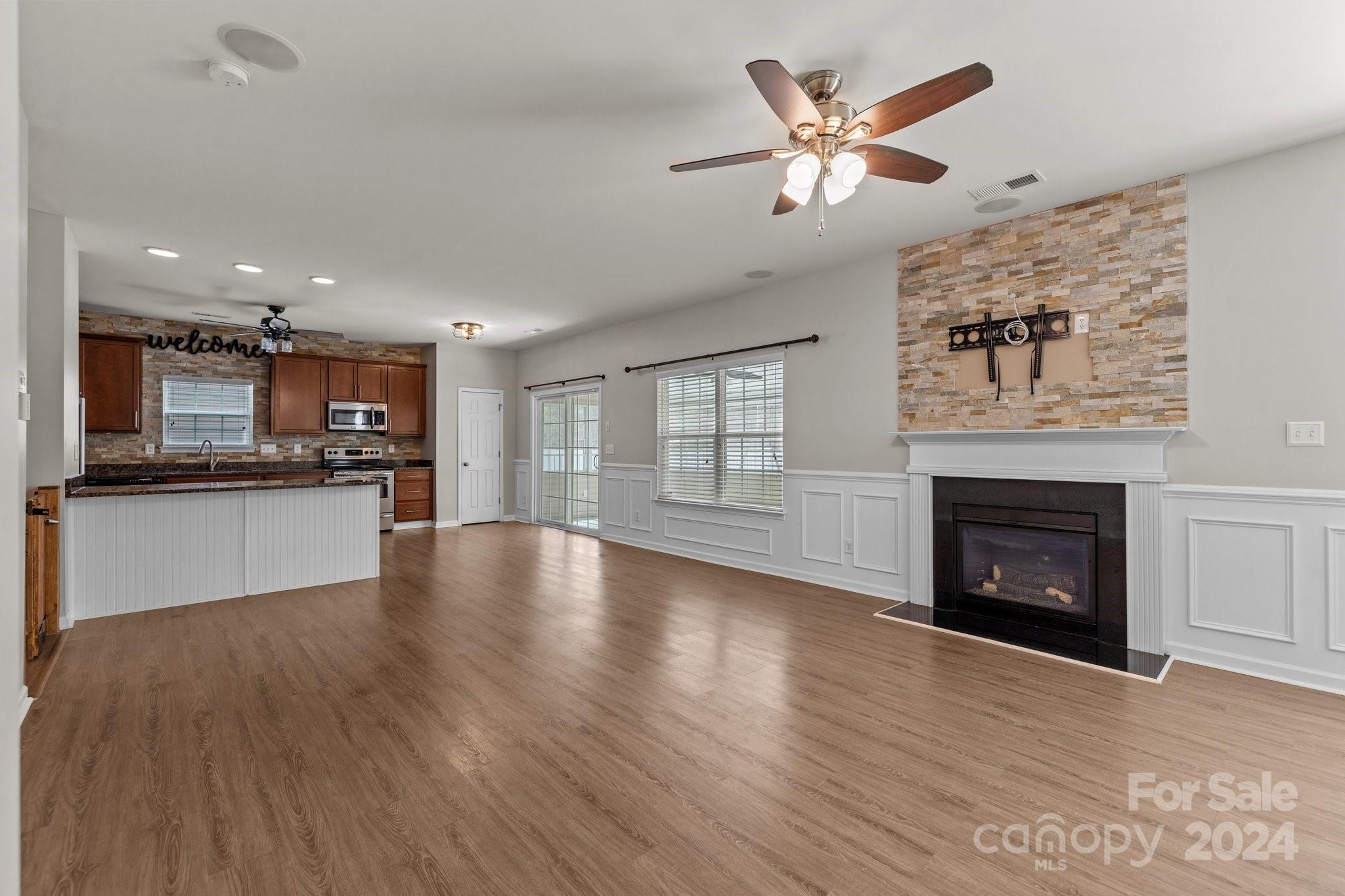 1653 Beleek Ridge Lane Clover, SC 29710 - Photo 17 of 46 a view of an empty room with a kitchen and a fireplace