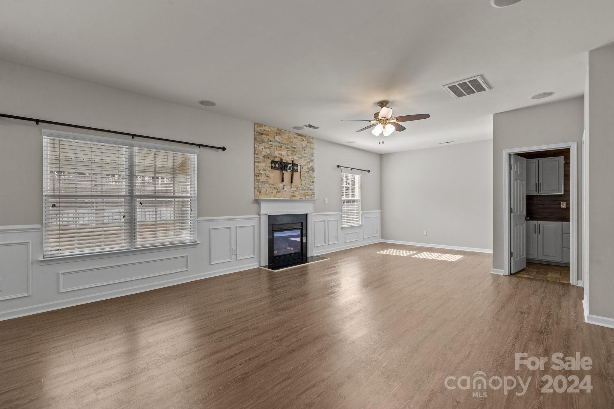 1653 Beleek Ridge Lane Clover, SC 29710 - Photo 18 of 46 an empty room with wooden floor chandelier and windows