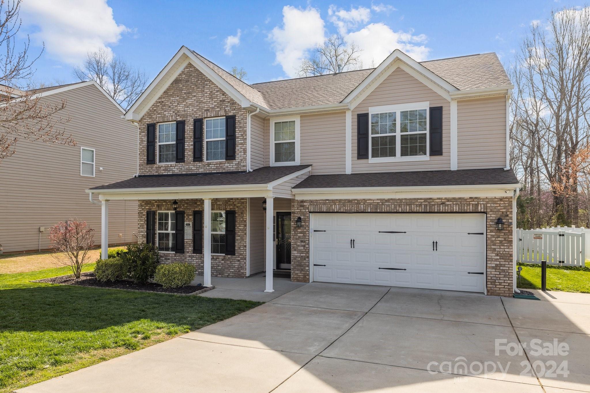 1653 Beleek Ridge Lane Clover, SC 29710 - Photo 2 of 46 a view of a white house with a yard plants and large tree