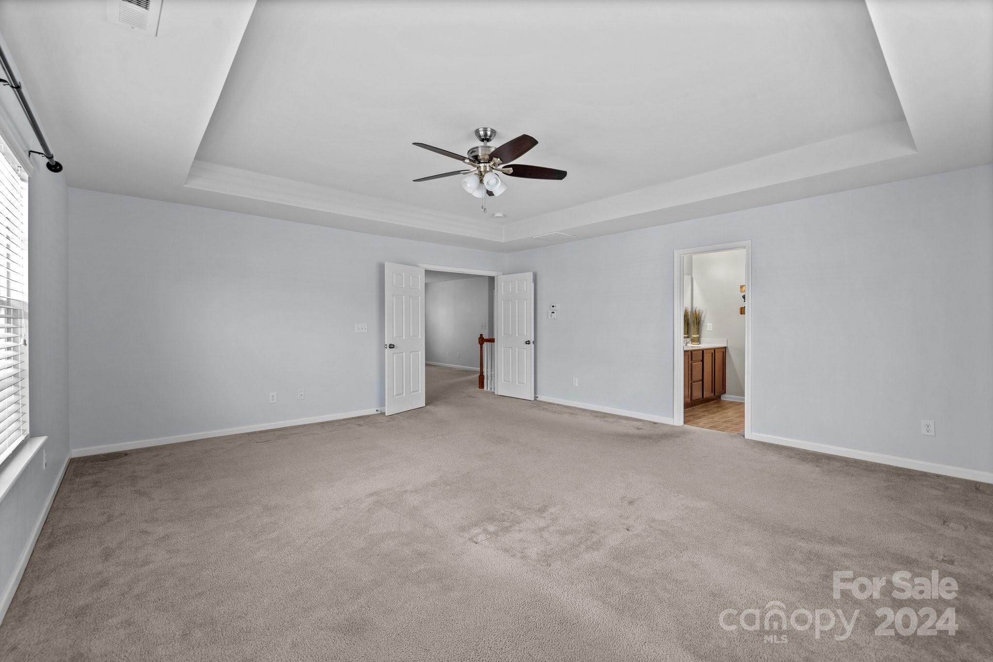 1653 Beleek Ridge Lane Clover, SC 29710 - Photo 25 of 46 an empty room with chandelier fan and windows