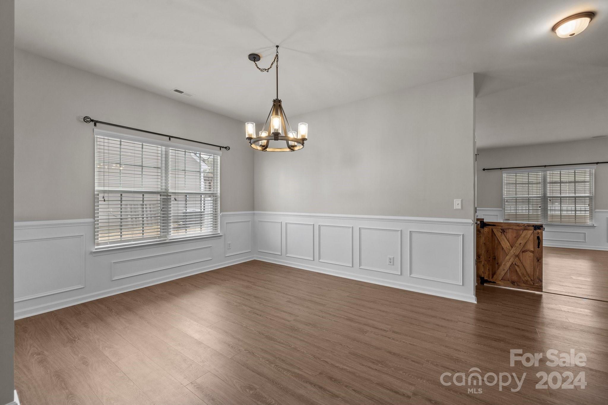 1653 Beleek Ridge Lane Clover, SC 29710 - Photo 7 of 46 a view of an empty room with wooden floor and a window