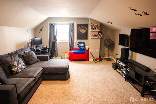 a living room with furniture gym equipment and a flat screen tv