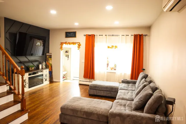a living room with furniture and a flat screen tv