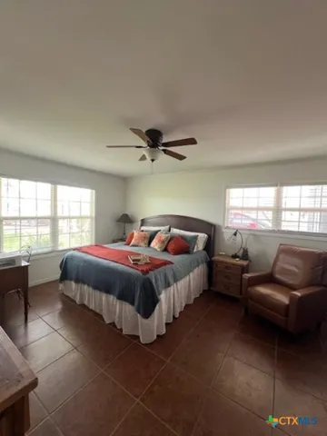 a spacious bedroom with a bed and a couch