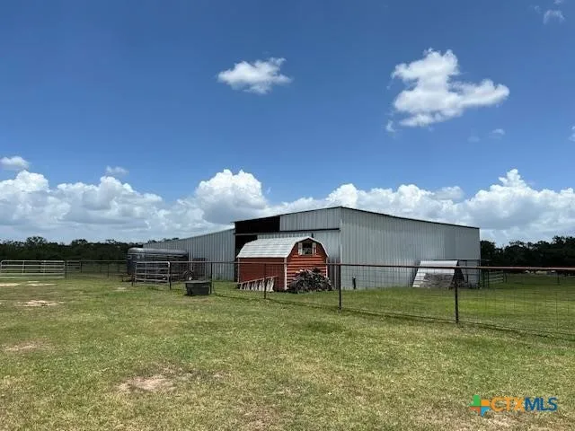 a table and chairs sitting in the patio next to a yard