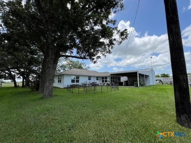 a backyard of a house with table and chairs