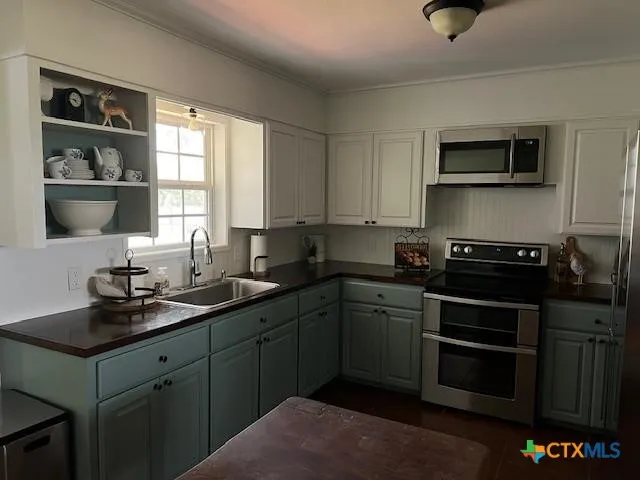 a kitchen with a sink stove and microwave