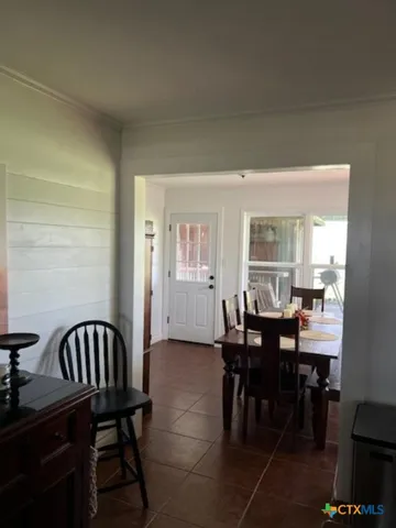 a view of a dining room with furniture and window