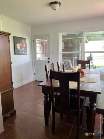 a dining room with furniture and window