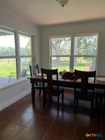 a view of a dining room with furniture and window