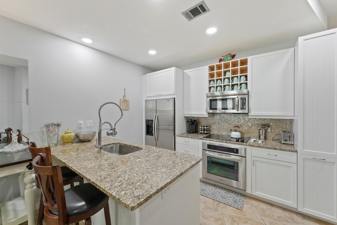 10327 Termini-San Luis Pass Road, Unit 319 Galveston, TX 77554 - Photo 11 of 28 Open to the dining room, there is also additional seating at the peninsula.