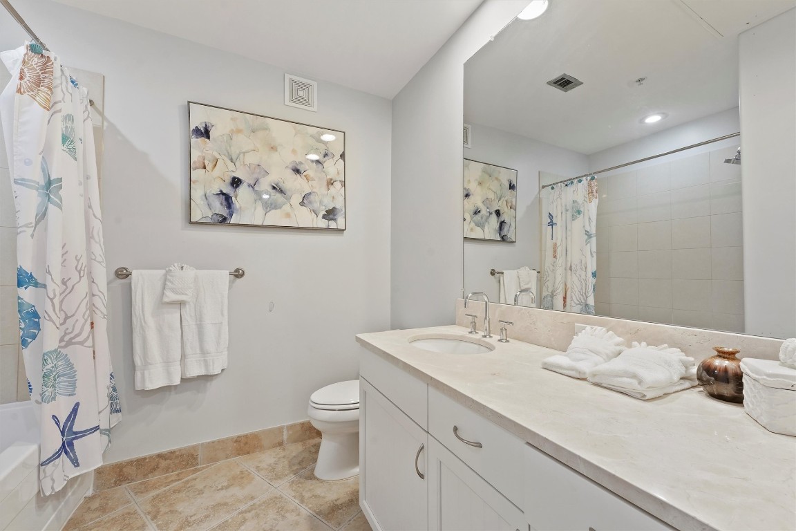 10327 Termini-San Luis Pass Road, Unit 319 Galveston, TX 77554 - Photo 9 of 28 ensuite bath with large soaking tub and double vanity sink.