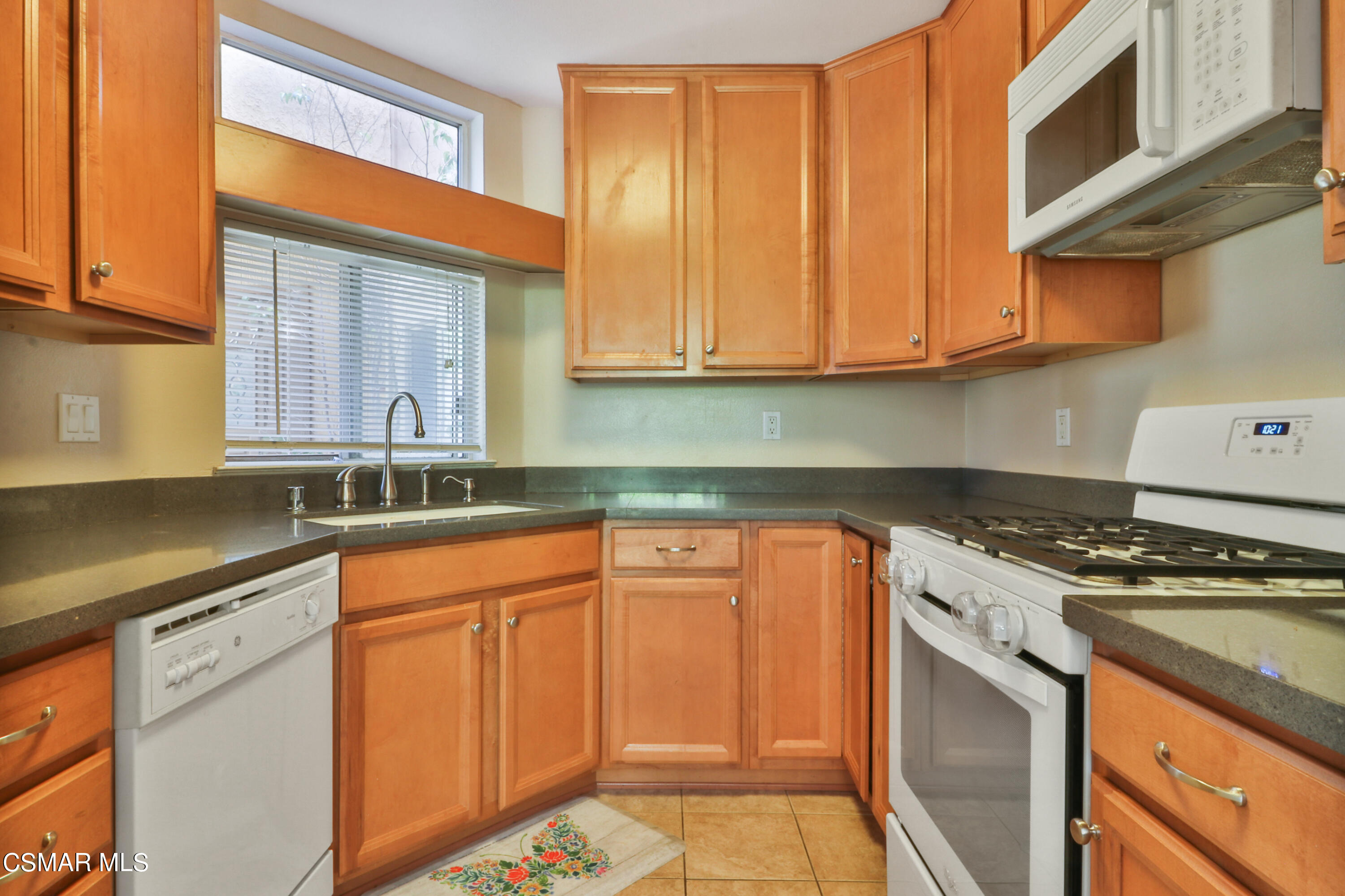 1724 Sinaloa Road, Unit 128 Simi Valley, CA 93065 - Photo 3 of 14 a kitchen with stainless steel appliances granite countertop a stove a sink and dishwasher