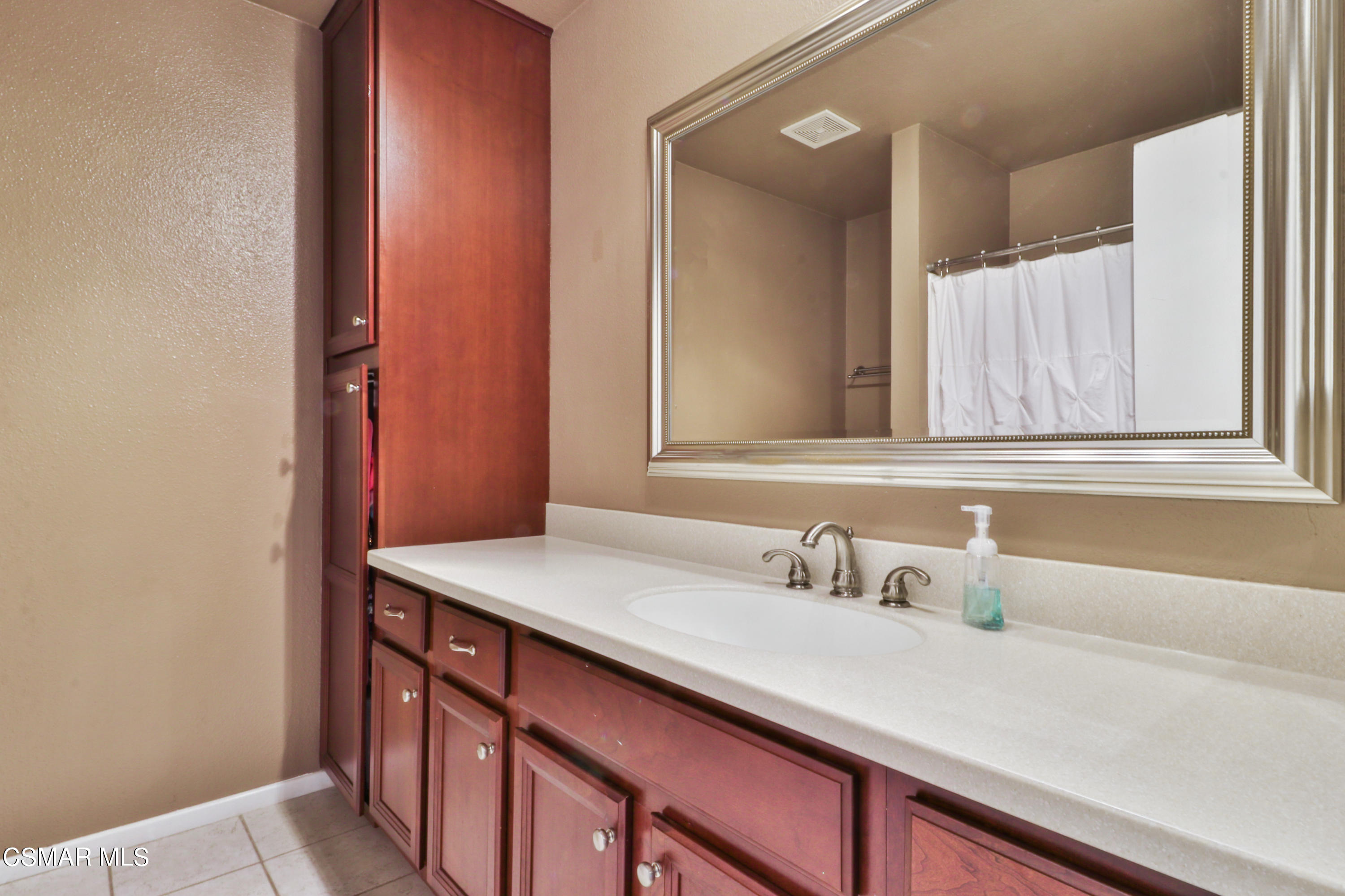 1724 Sinaloa Road, Unit 128 Simi Valley, CA 93065 - Photo 4 of 14 a bathroom with a sink and a mirror