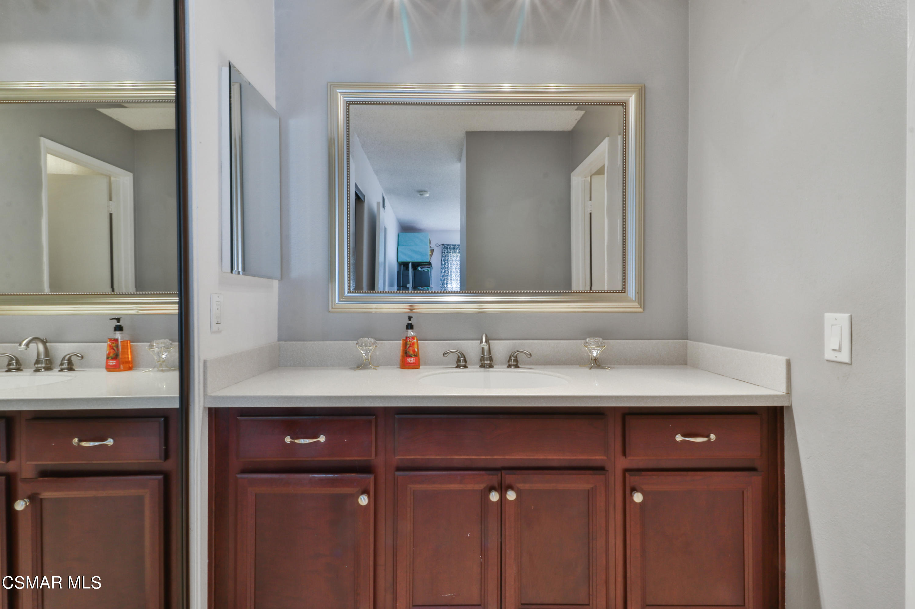1724 Sinaloa Road, Unit 128 Simi Valley, CA 93065 - Photo 7 of 14 a bathroom with a sink vanity and a mirror