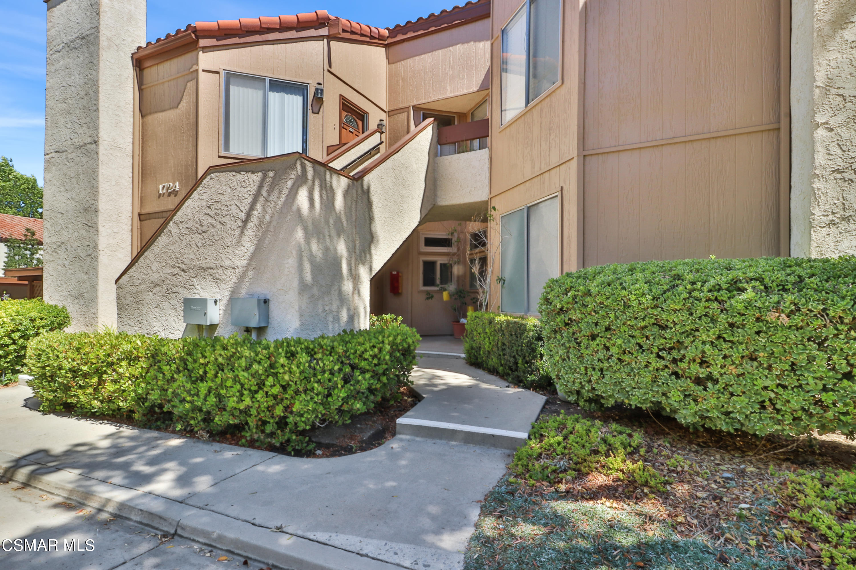 1724 Sinaloa Road, Unit 128 Simi Valley, CA 93065 - Photo 10 of 14 a front view of a house with garden