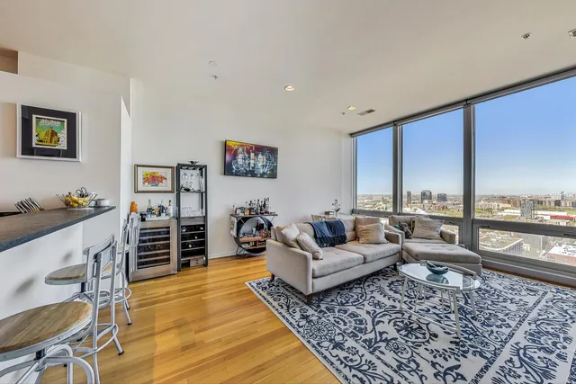 a living room with furniture and large windows