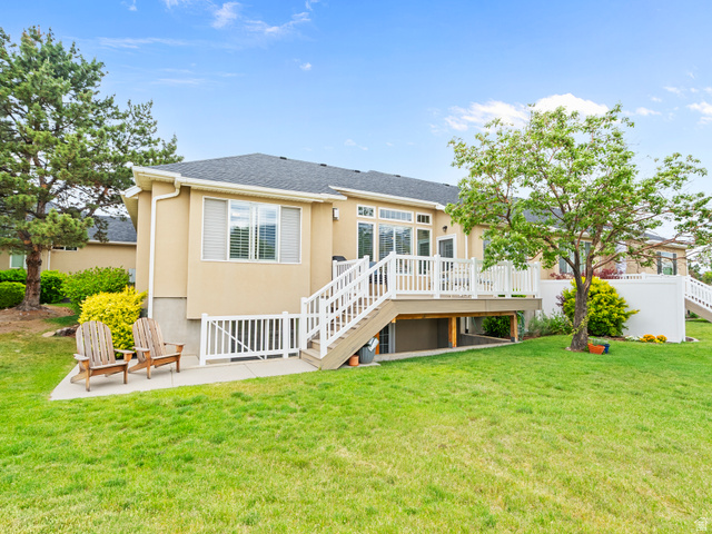 11881 Cottage View Lane Draper, UT 84020 - Photo 21 of 29 Expansive lawn with a raised deck, white railings, and mature trees
