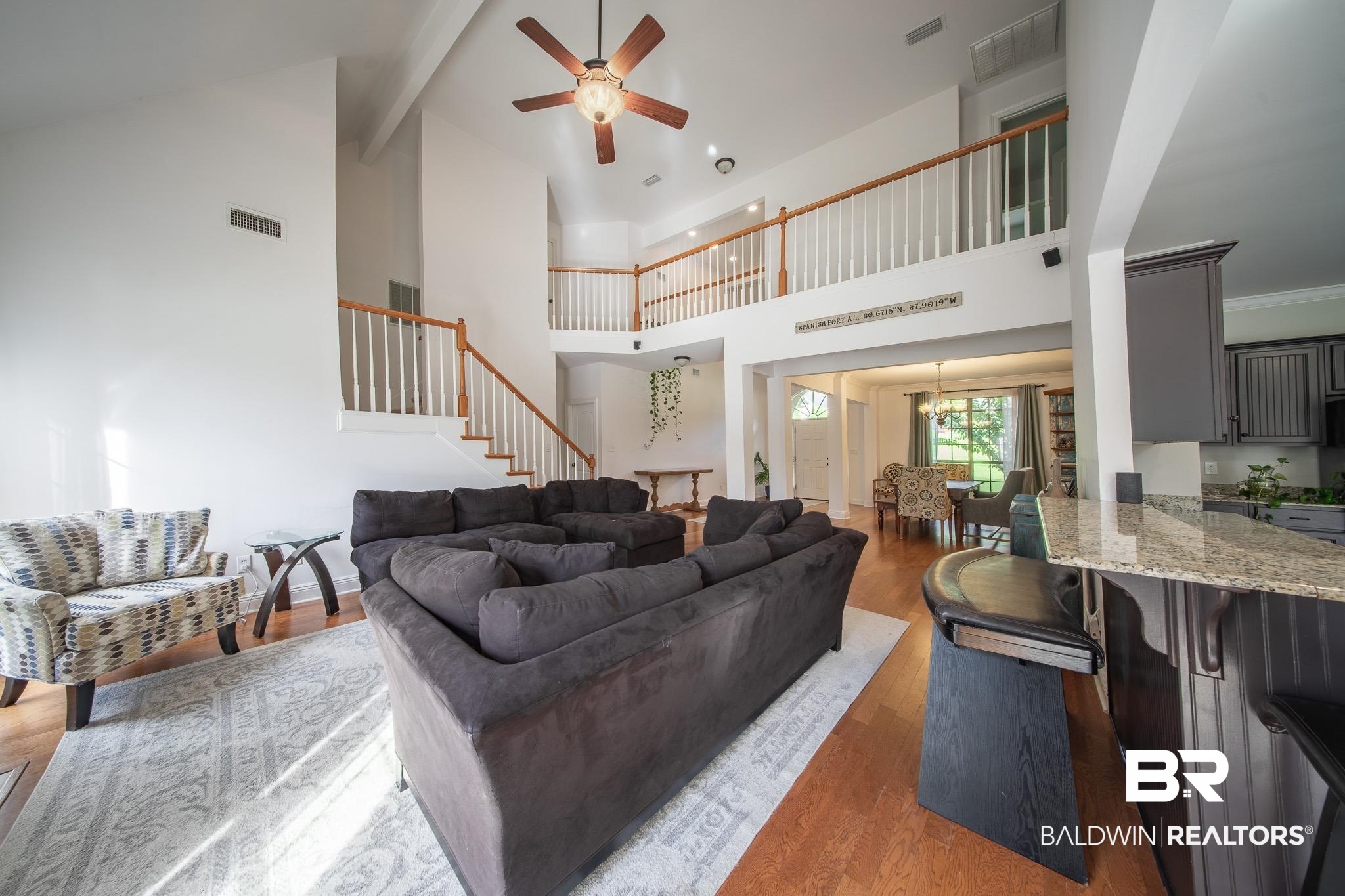 8421 Weatherford Court Daphne, AL 36527 - Photo 9 of 36 Living area with a ceiling fan, wood finished floors, stairs, high vaulted ceiling, and beamed ceiling