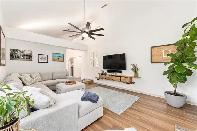 a spacious bathroom with a granite countertop sink a mirror and a bathtub