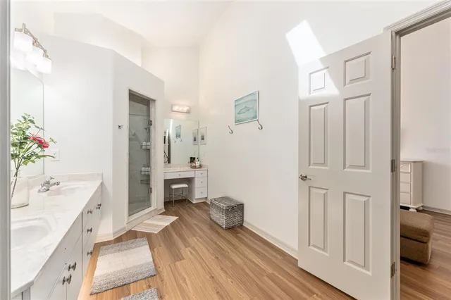 a bedroom with furniture and wooden floor